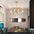 Gold mid-century modern chandelier with frosted glass cylinders illuminating a contemporary dining room.