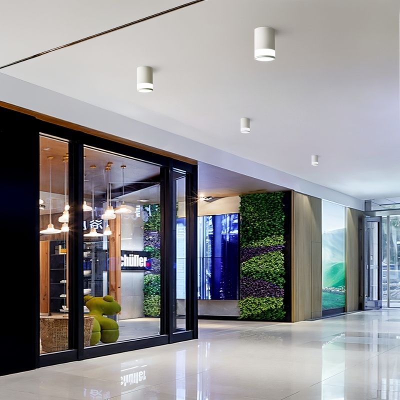 "Sleek ceiling lights in a commercial space, offering functional lighting and a modern aesthetic. Perfect for use in offices, lobbies, or corridors."