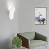 "Contemporary wall lamp made from gypsum and aluminum, featuring an organic design that directs soft light upward, perfect for modern interiors like hallways, living rooms, or bedrooms."