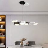 "A hexagonal pendant light with multiple heads, illuminating a modern dining room with a round table."