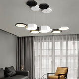 "A hexagonal pendant light with multiple heads, illuminating a modern living room with a sofa and armchair."