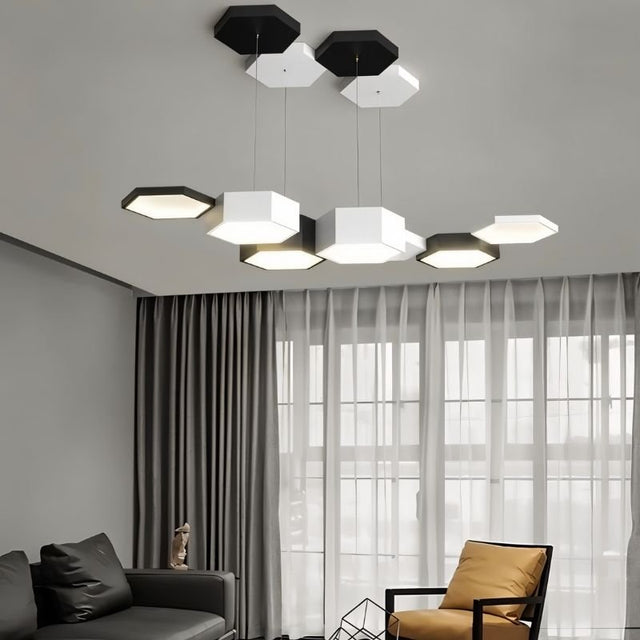 "A hexagonal pendant light with multiple heads, illuminating a modern living room with a sofa and armchair."