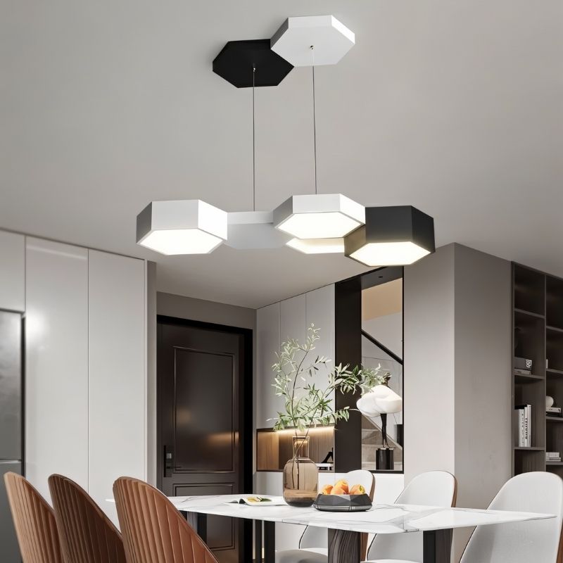 "A hexagonal pendant light with multiple heads, suspended above a dining table, providing modern and geometric illumination."