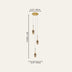 Three-light pendant chandelier with brass canopy and gold teardrop glass shades on white cords.