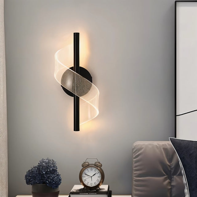 "Modern sculptural wall lamp with a spiral acrylic diffuser adding a decorative touch and soft lighting to a contemporary living room."