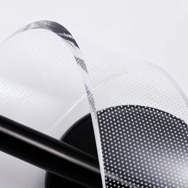"Close-up detail of a spiral acrylic diffuser on a modern sculptural wall lamp, showing its texture and design."