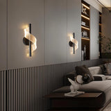 "Pair of modern sculptural wall lamps with spiral acrylic diffusers flanking a wall in a contemporary living room, providing soft, ambient lighting."