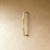 Brushed nickel curved cabinet pull with decorative wave design, front view on white background, 5 inch width.