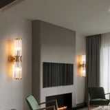 "Pair of modern wall lamps with clear glass panels flanking a television on a feature wall in a living room."