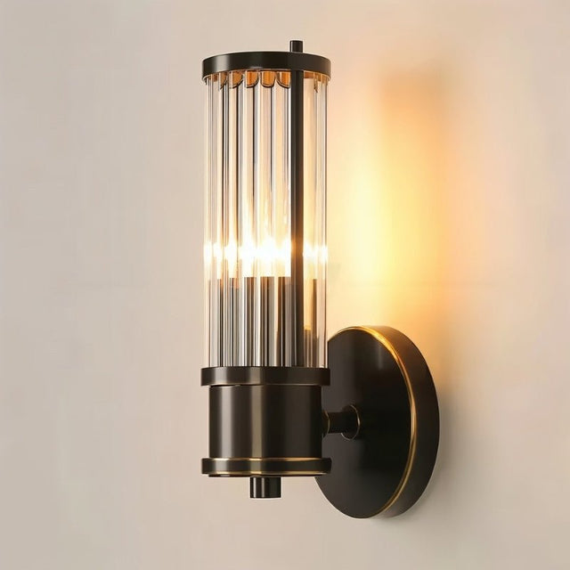 "A modern wall lamp with clear glass panels stacked on a sleek frame, emitting a warm glow."