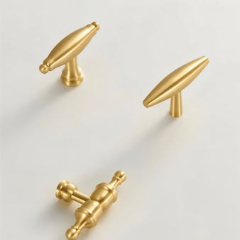 "Brass cabinet knobs with a refined, sculptural design and elegant curves."