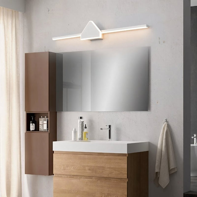 "A modern white wall lamp with a geometric centerpiece and streamlined bar, mounted above a bathroom vanity mirror in a contemporary bathroom with a wooden cabinet."