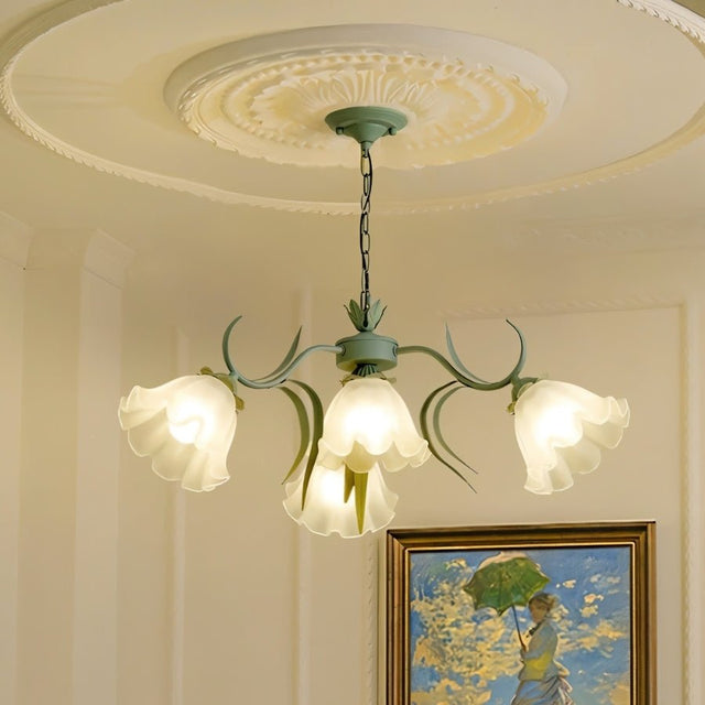 "A floral chandelier with curved arms and frosted glass shades resembling blooming flowers, hanging from a decorative ceiling medallion."