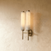 Modern cylindrical wall sconce with circular backplate, polished chrome finish, shown in profile view against white backgroun