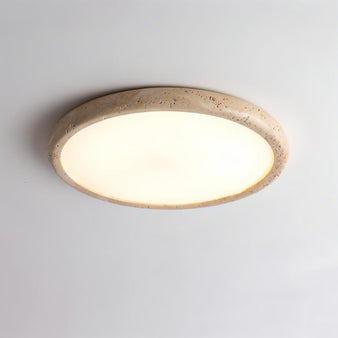 "A modern travertine flush mount ceiling light with a circular design, featuring a natural stone frame and a white acrylic diffuser."