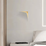 "A recessed trimless wall light casting a soft glow on a bedroom wall, providing ambient lighting."