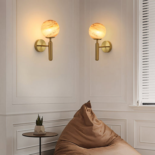 Cosima Modern Brass Wall Lamp: Featuring a sleek brass finish and minimalist design, this wall lamp adds a contemporary touch to any space.