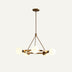 Brass chandelier with frosted glass globe shades suspended from triangular frame on neutral background.