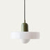 White ribbed pendant light with sage green metal canopy hanging from black cord against neutral background.