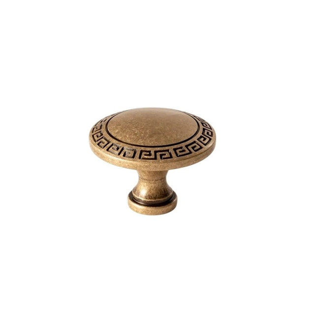"Vintage solid brass knob with an intricate Grecian-inspired pattern, perfect for adding character to classic or heritage cabinetry."
