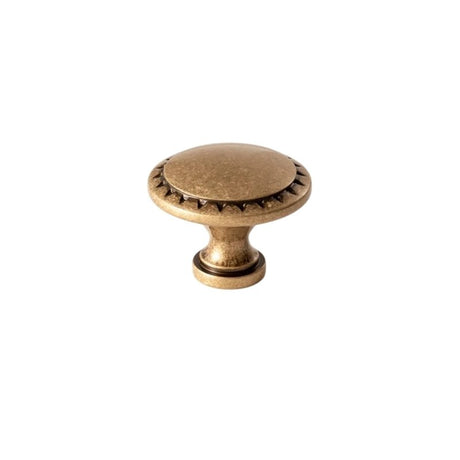 "Vintage solid brass knob with intricate detailing and textured surface, adding depth and character to cabinetry."