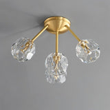 "Modern 4-light ceiling fixture with crystal shades and brass finish."