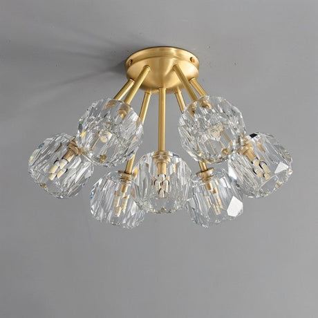 "Modern flush mount ceiling light with crystal shades and brass finish."