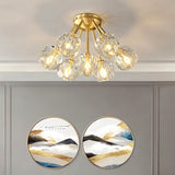 "Modern ceiling light with crystal shades and brass finish in a living room, illuminating artwork and decor."