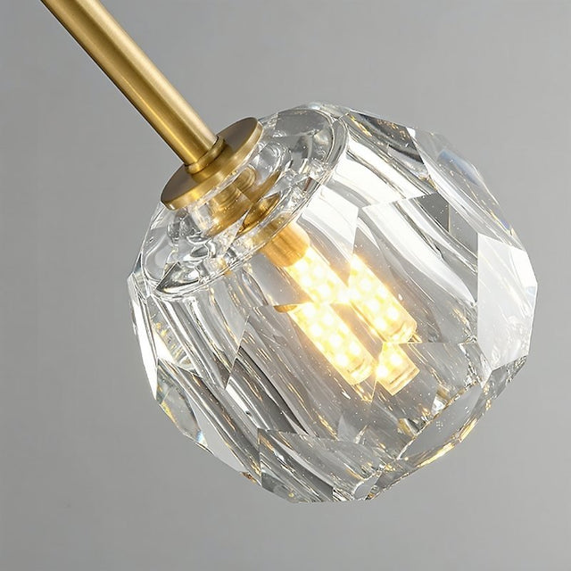 "Close-up of a crystal shade with a visible light bulb in a modern ceiling light fixture."