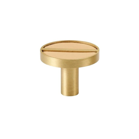 "Circular brass knob with a tan leather inlay and central bar, isolated on a white background."