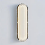 "Modern elongated wall lamp with a textured acrylic diffuser and a sleek metal frame."