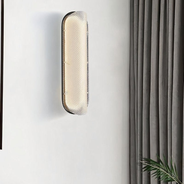"Modern elongated wall lamp with a textured acrylic diffuser, providing ambient lighting in a contemporary space."