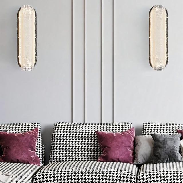 "Pair of modern elongated wall lamps with textured acrylic diffusers, mounted on a wall above a sofa in a contemporary living room."