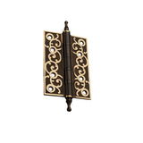 "Dark brass door hinge with ornate scrollwork design, isolated on a white background."