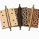 "Collection of brass door hinges with decorative scrollwork, showing a variety of finishes and designs."