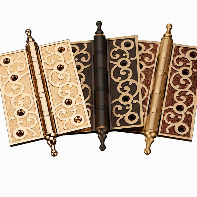 "Collection of brass door hinges with decorative scrollwork, showing a variety of finishes and designs."