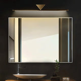 "A modern, linear LED wall lamp with a geometric accent illuminating a bathroom mirror with a sink."