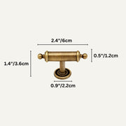 Antique brass cabinet pull with cylindrical handle and round base plate on beige background.