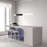 "Modern pendant light with a marble accent and acrylic tubes illuminating a kitchen island."