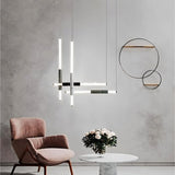 "Modern geometric pendant light with acrylic tubes and marble accents in a contemporary living room setting."