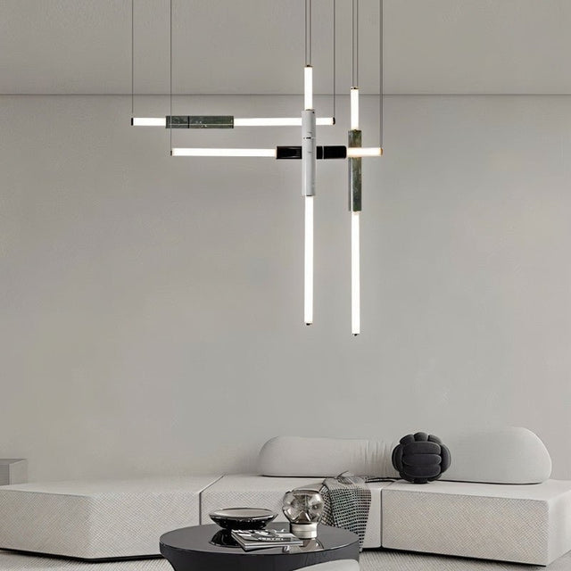"Modern geometric pendant light with acrylic tubes and marble accents in a contemporary living room."