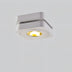 White ceiling downlight with adjustable trim and warm LED glow against neutral background.