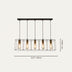 # Five-light linear chandelier with black metal frame and brass accents against white background.
