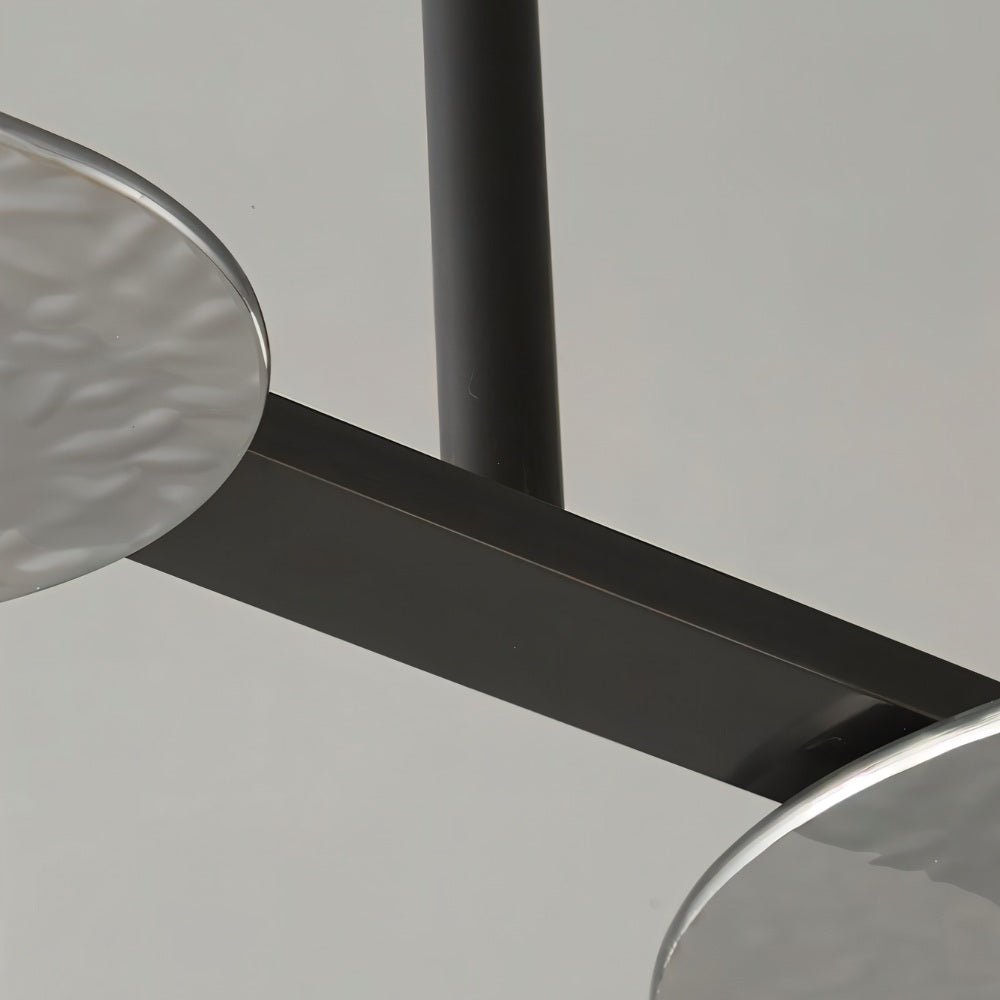 "Close-up detail of a copper Dilti pendant light showing the frame and metal disc."