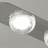 "Close-up of a copper Dilti pendant light showing a glass globe and textured metal frame."