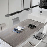 "Modern linear pendant light with silver frame and clear glass globes hanging above a dining table."