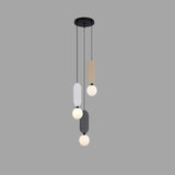 "The Dorea Pendant Lamp with four glass globes and colorful fabric panels offers modern, ambient lighting, perfect for illuminating a dining area."