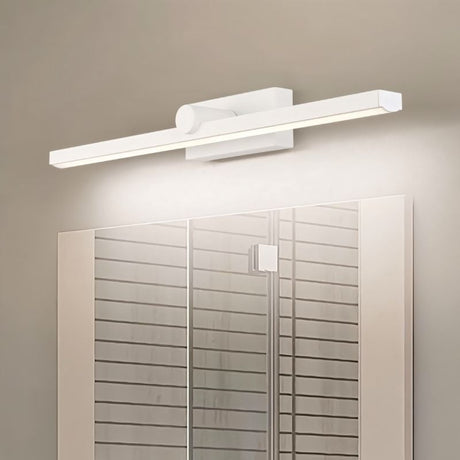 "A white LED vanity light mounted above a bathroom mirror with a patterned glass door."