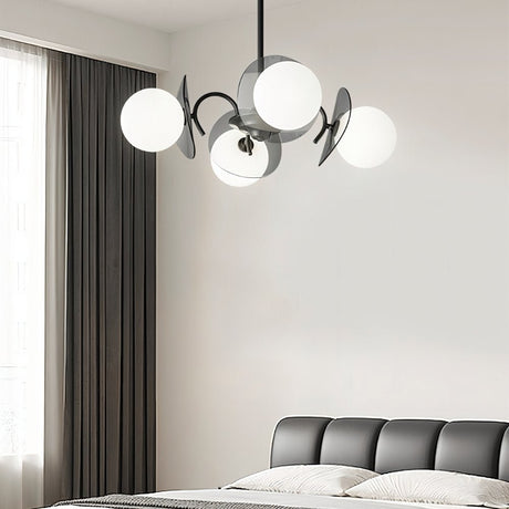 "Copper Dyana chandelier with frosted glass globes hanging above a bed with a grey headboard."