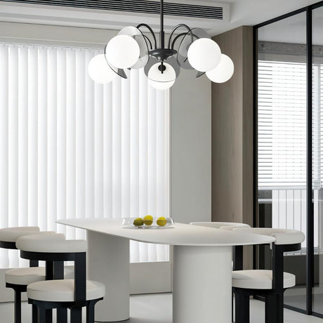 "Copper Dyana chandelier with frosted glass globes hanging above a white dining table with chairs."